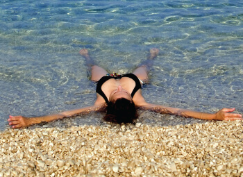 Mind Your Body Woman Laying And Relaxing At The Sea